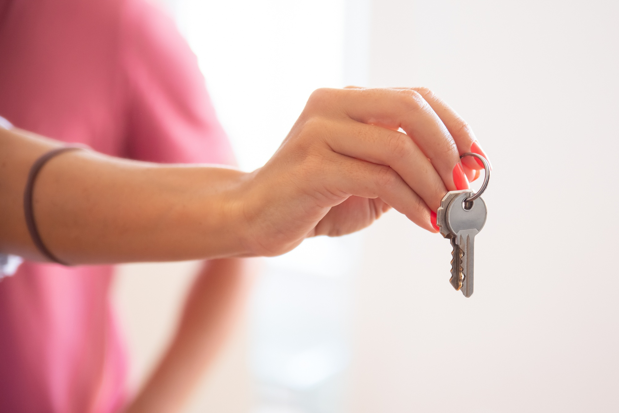 A pair of hands handing over a set of new keys