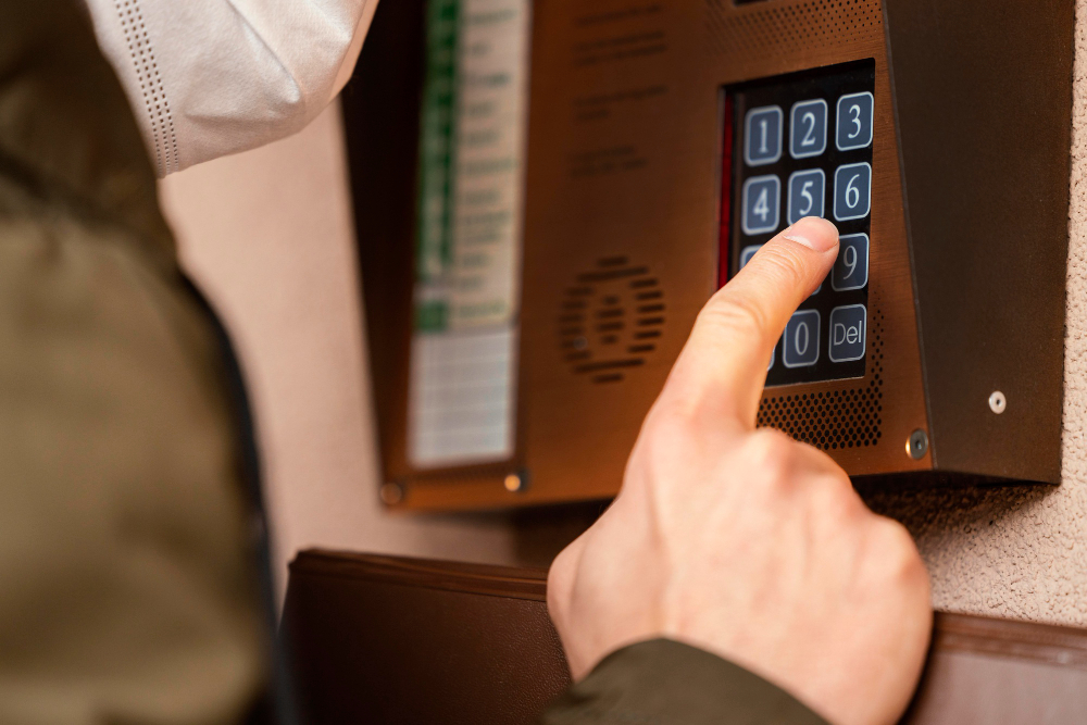 A hand accessing a set of Keypads on a home lock system