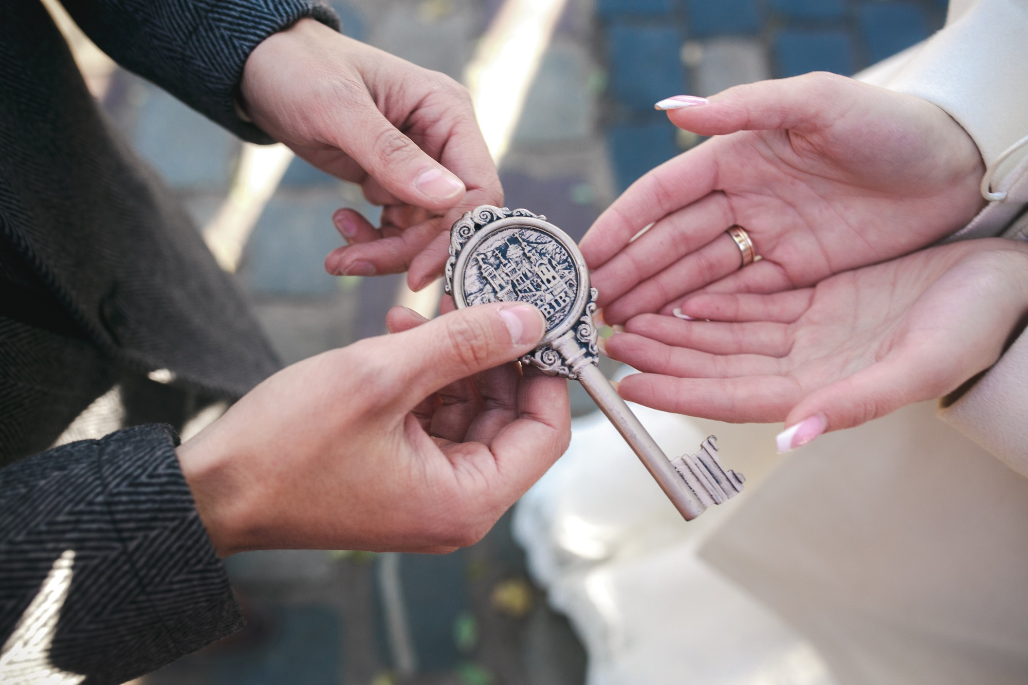 A locksmith handing over an ornate key to a homeowner